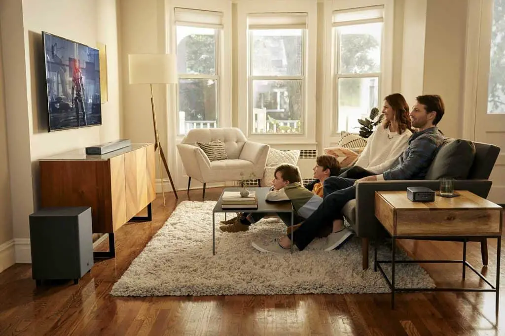 Family watching tv in living room, using jbl bar 9.1 soundbar